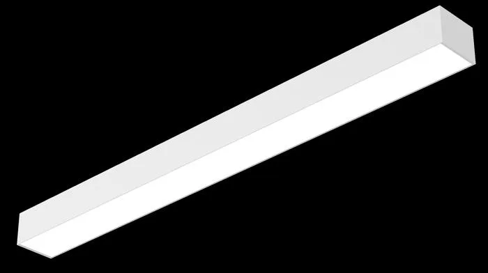 A slim white rectangular linear LED fixture seen from below at an angle, its long lit face glowing white, on a plain black background.